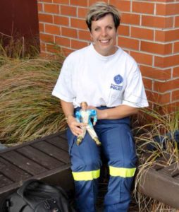 Constable Tanya Curtis with the ‘Ken’ doll mascot used for DVI training